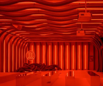 Shiny seating area surrounded by corrugated tubes in Everywhere & Nowhere installation
