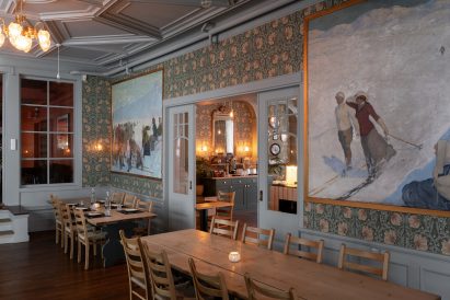 Dining room of Hotel Finse 1222 hotel with floral wallpaper and wooden furniture