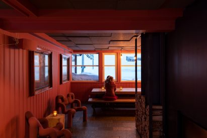Red-tinged Interiors of hotel lobby designed by Snøhetta