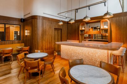 Cafe inside The Gessner with terrazzo counter and leather chairs