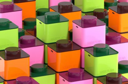 Houseplant containers in green, pink and orange stacked