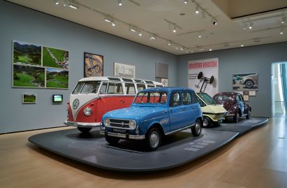 A small blue car and a camper van