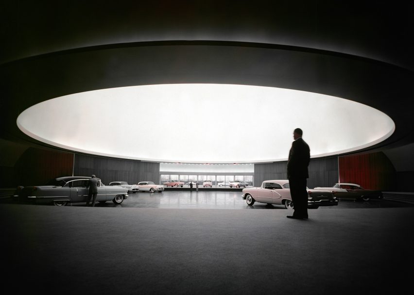A man standing in front of General Motor cars