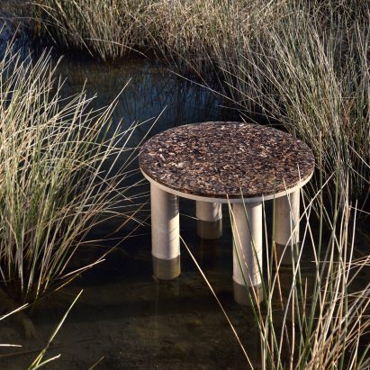 Round Oceanides table with four legs in a grassy wetland