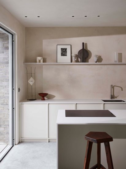 Kitchen interior by Daytrip with simple white cupboards