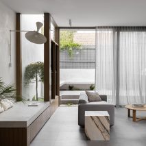 Living room interior of Ripponlea House by Luke Fry with window seat and grey couch