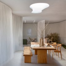 A dining room with white curtain dividers