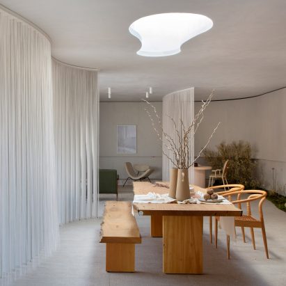 A dining room with white curtain dividers