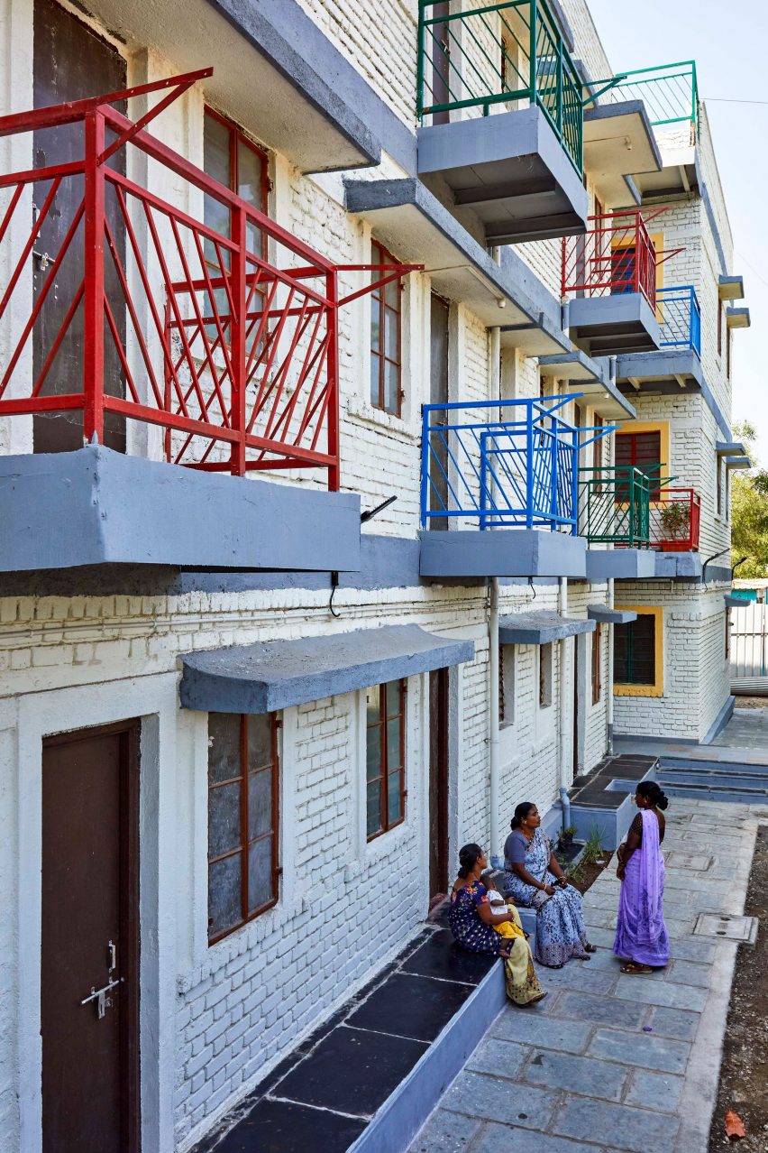 Colourful balconies on white brick building