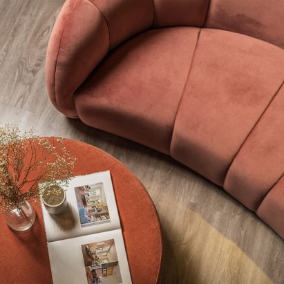 Orange Stax Recycled velvet by Texstyle used as upholstery on a curved sofa