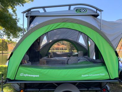 View through the Go camping trailer at a lake