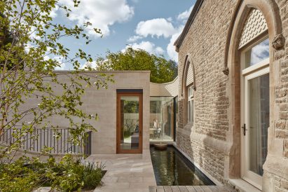 Stone-clad house and extension
