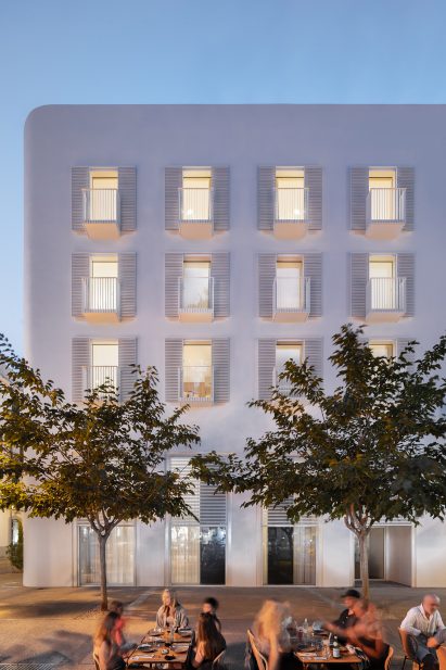 Exterior image of The Standard Ibiza with people sat at tables outside