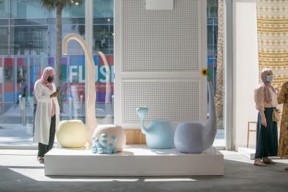 A photograph of a person looking at a design collection as part of Downtown Design