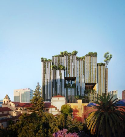 glass building with trees with adobe buildings around it
