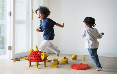 A photograph of children playing around a creative creature construction kit