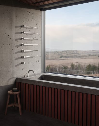 A photograph of the bathroom in Arborg House, which features Vola's stainless steel products