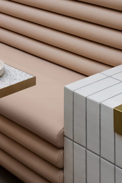 Flesh coloured bench seating in cafe by Mim Design