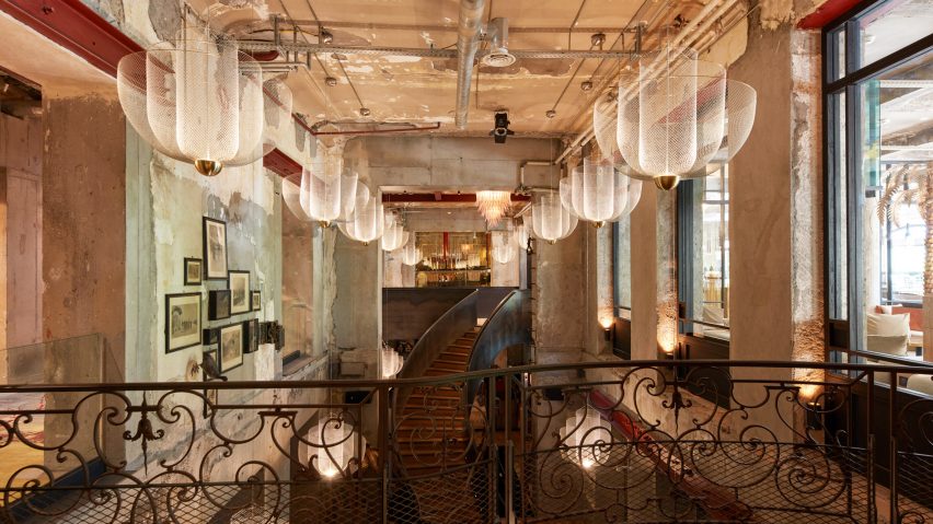 Modern chandeliers above grand atrium in La Folie Douce Hôtel Chamonix by Bachmann Associés