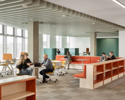 Interior image of people sat on colourful furniture