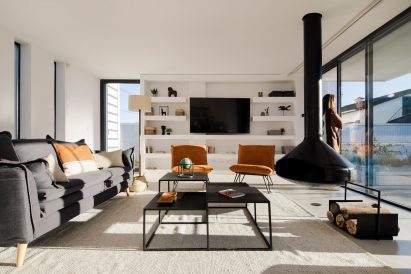 Living room with suspended fireplace in Cork House by Inês Brandão Arquitectura