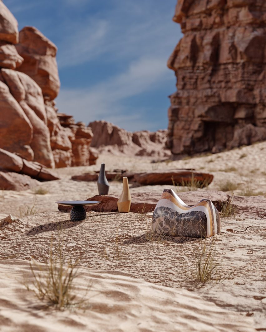 Clay carafes and a curved stone vase from Adorno's Departures collection photographed in the sands of the Wadi Rum desert