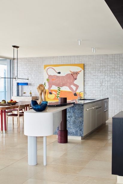 Kitchen interior of apartment by YSG with blue stone counter and breakfast bar
