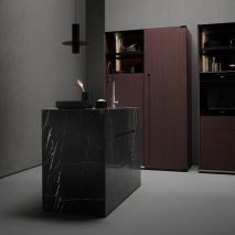 Black marble kitchen island in a dark grey kitchen