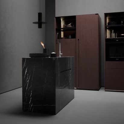Black marble kitchen island in a dark grey kitchen