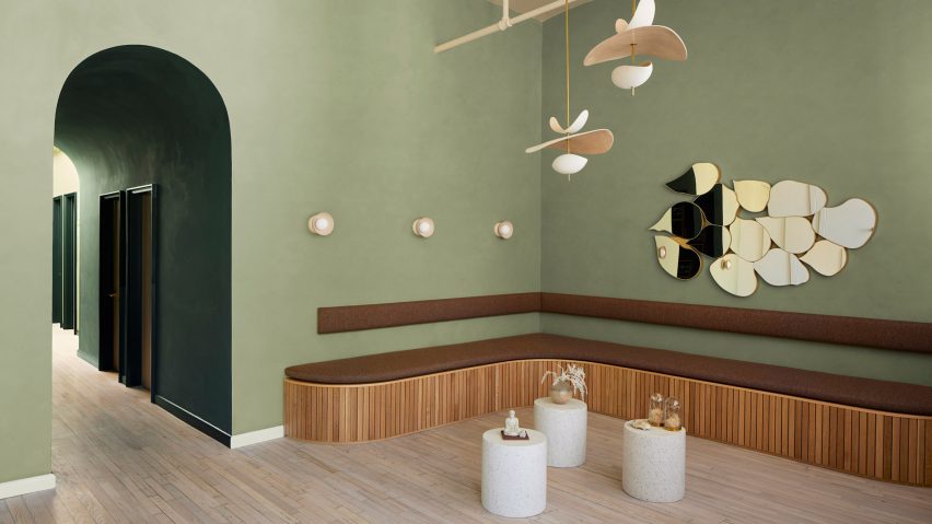 A green atrium with sculptural pendant lights