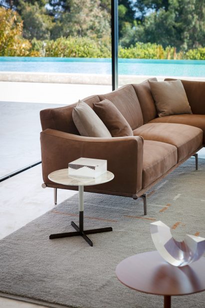 Happy Jack sofa in brown fabric in a living room with a side table