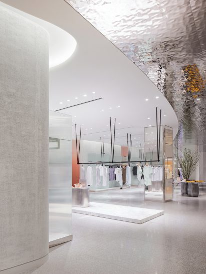 Women's department with rippled mirror ceiling in mall by Burdifilek