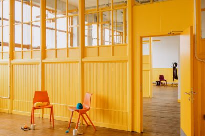 Yellow interior of Kinning Park Complex renovation by New Practice