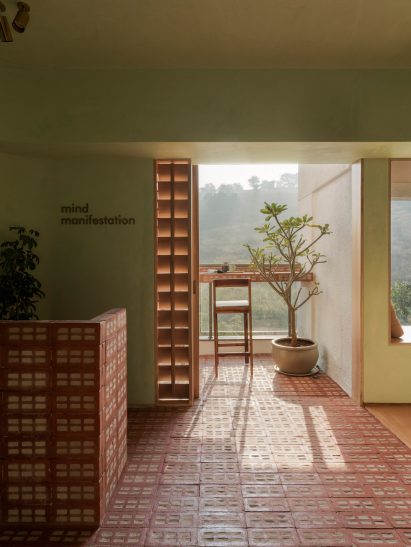 Reception and terrace of Mind Manifestation's self-designed studio with perforated brick flooring