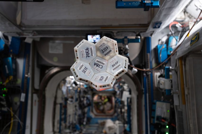 A cluster of white modular tiles floating in space