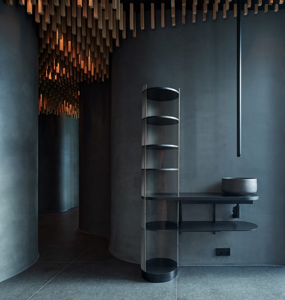 Dark cement spa interior with sink and storage