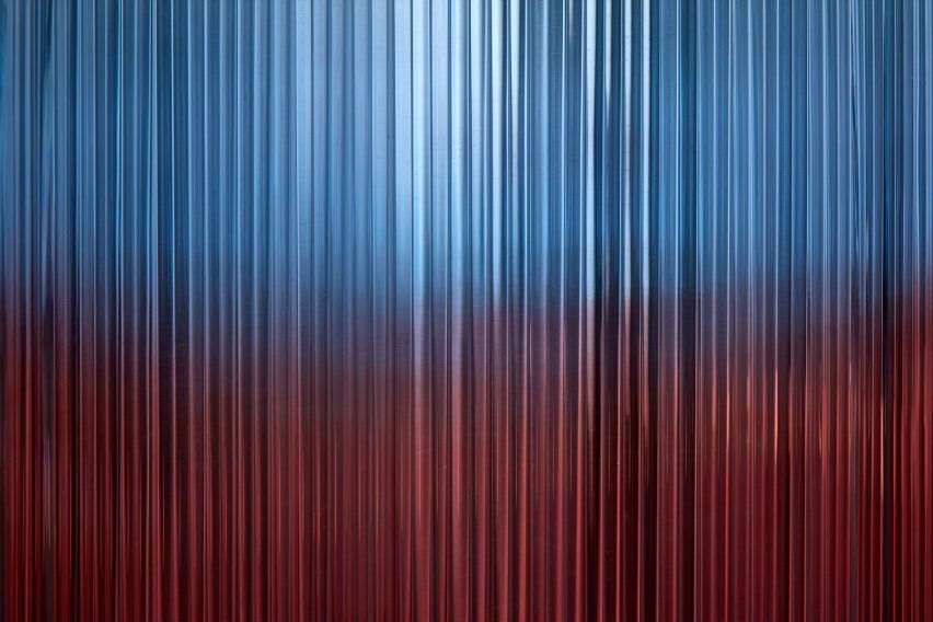 Close up view of illuminated glass rods – blue above and red below