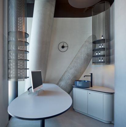 The lighter interior inside the office with structural columns visible