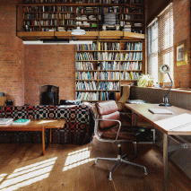 An open plan study with a desk and leather work chair