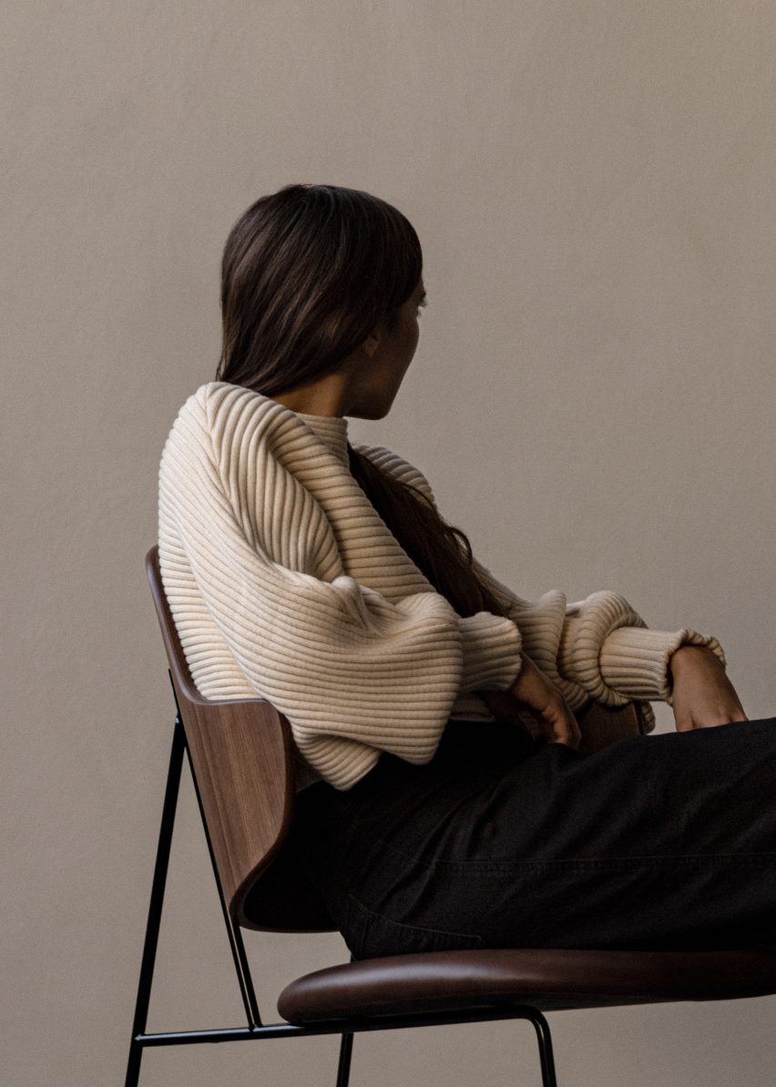 Side-on image of figure sitting on Penguin Lounge Chair