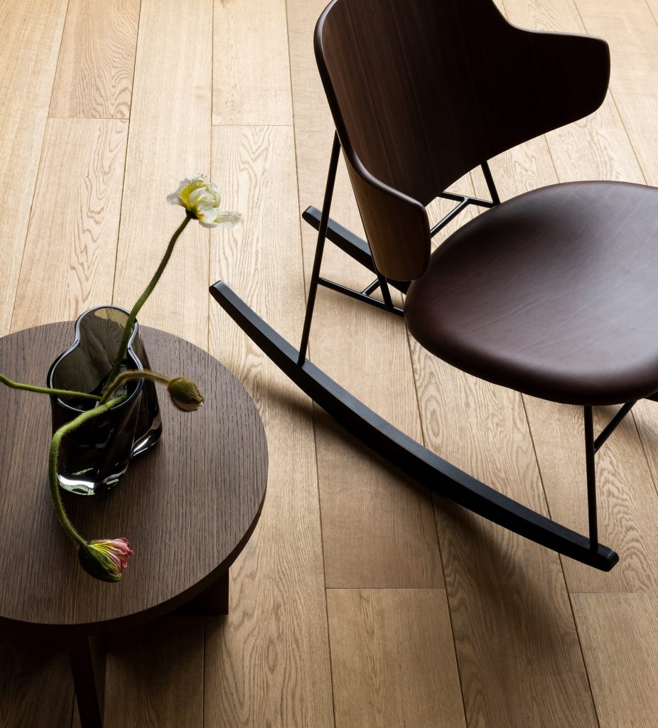Rocking version of the Penguin Chair from above beside an end table