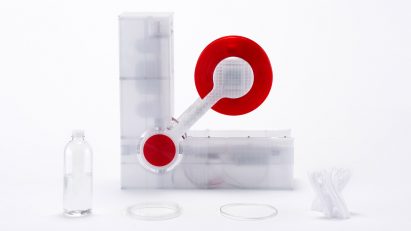 Polyformer recycling machine by Reiten Cheng next to a plastic bottle