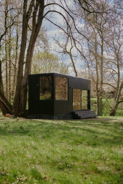 Timber-clad cabin with large windows
