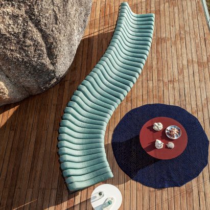 Songololo sofa in aqua blue photographed from above on a wooden deck