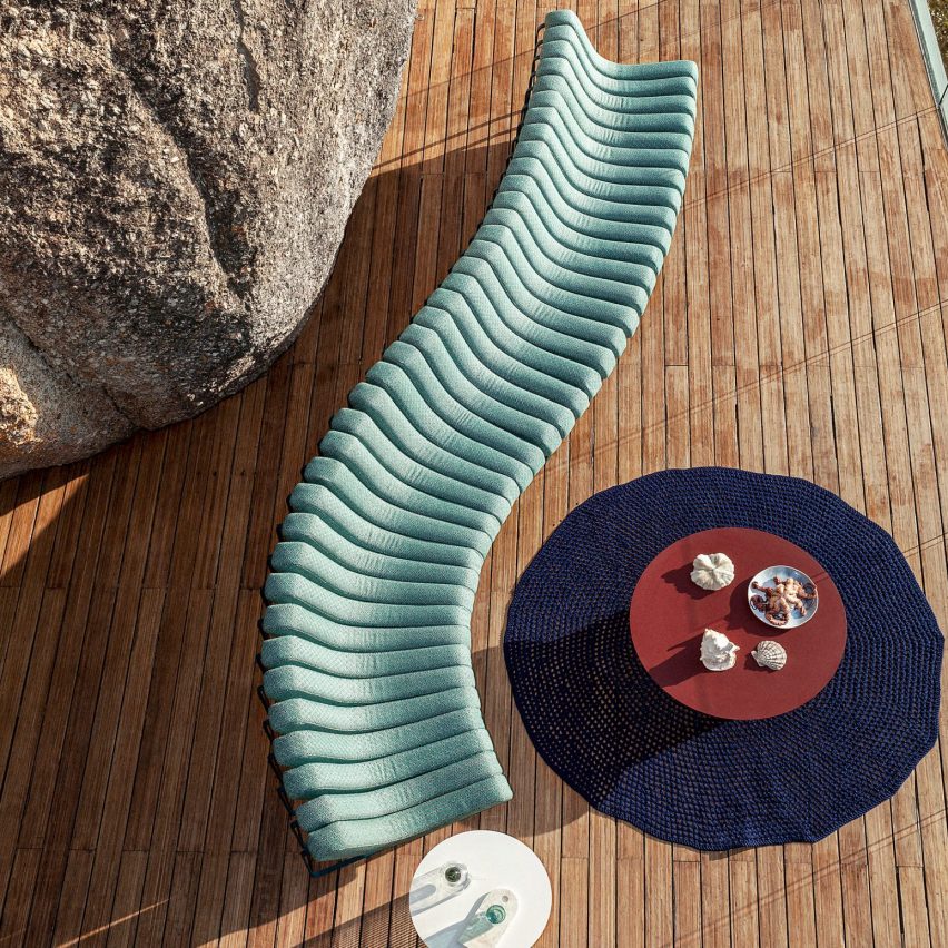 Songololo sofa in aqua blue on a wooden deck