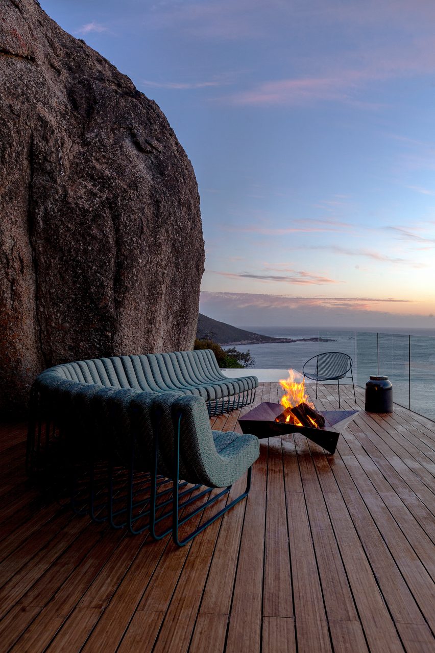 Songololo sofa photographed at night curved around an outdoor fire