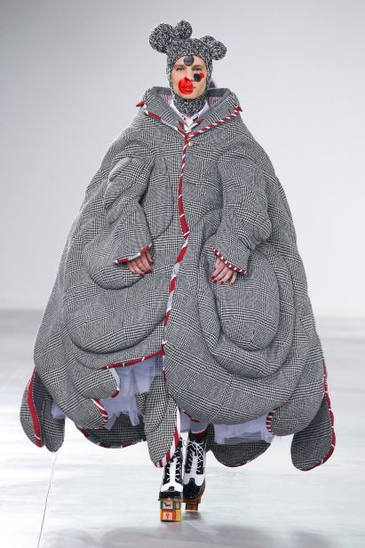 A model is pictured wear a grey tweed jacket which looks as though it is melting