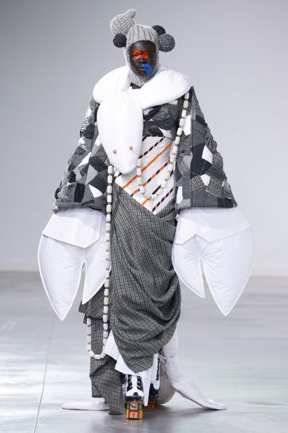A model at the Thome Browne show is wearing a jacket with stuffed lobster claws