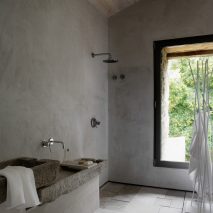 Limestone tiles cover the floors of a wet room