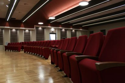A photograph of the red conference room seats